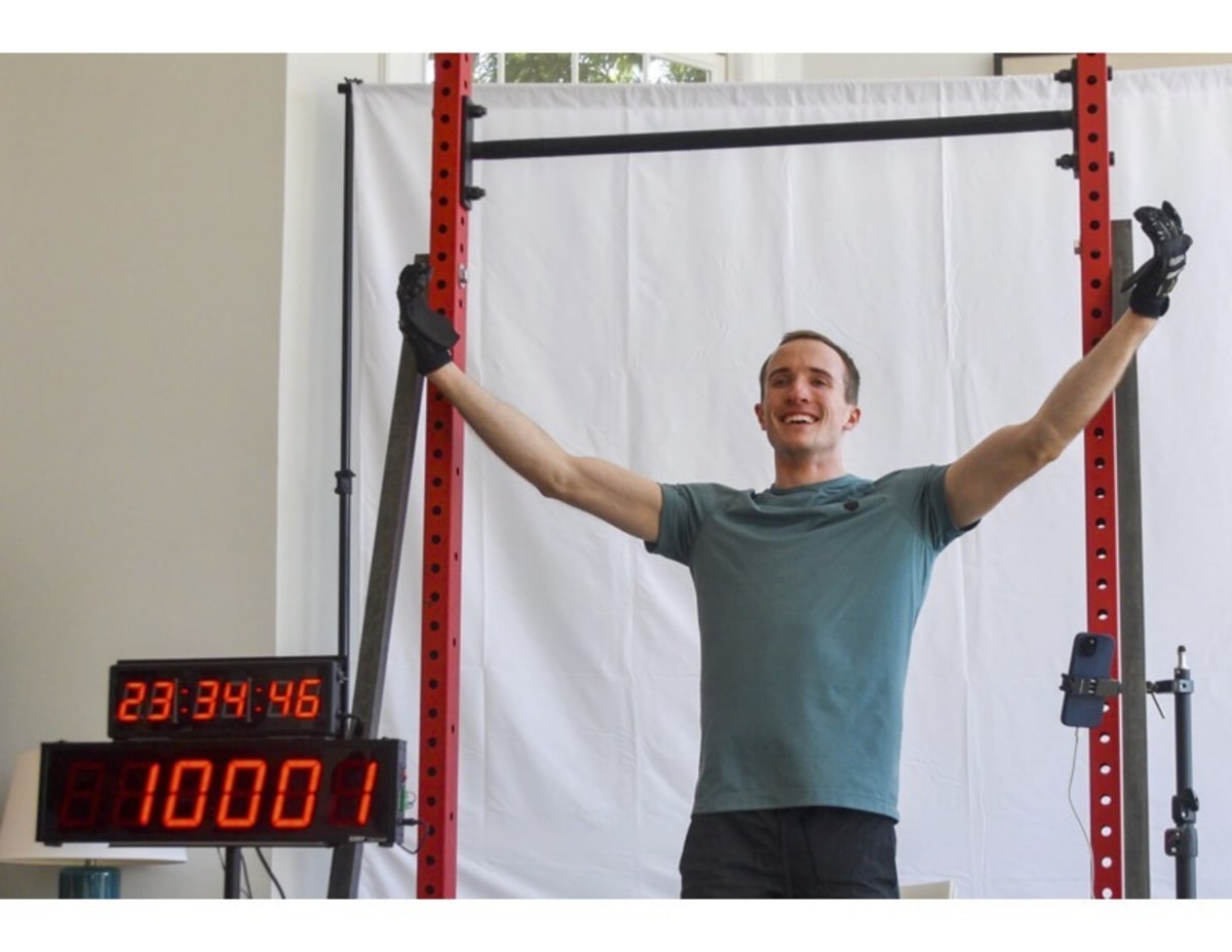 David Brush hanging from chin-up bar during his 24-hour world record attempt at home