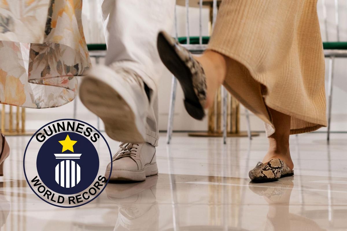 ** Nursing home residents and staff dancing joyfully while seated in chairs during world record event