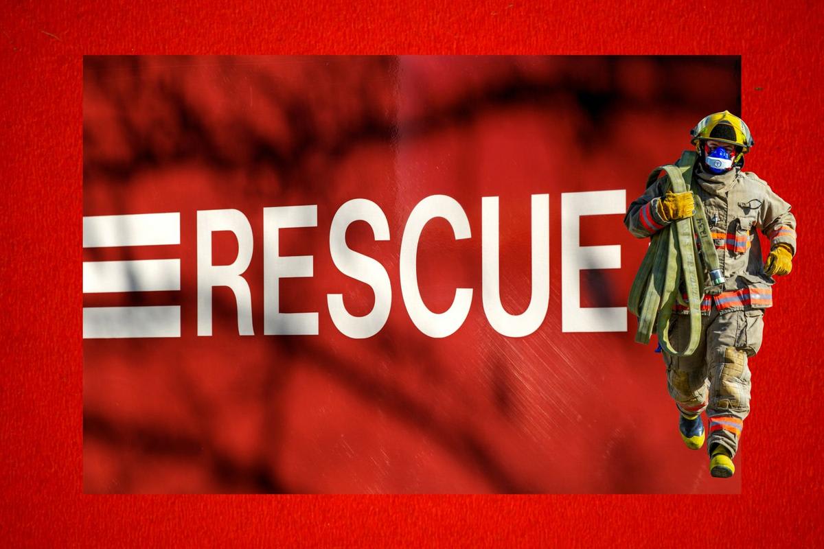 Firefighters in protective gear performing technical rescue operation at apartment building