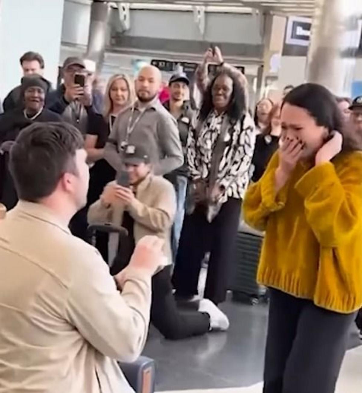 ** Man proposing on one knee to woman at decorated Chili's restaurant inside O'Hare Airport