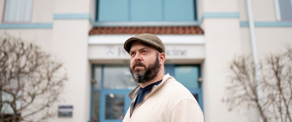 Dennis Massimo and his sister Lauren standing together on front porch smiling