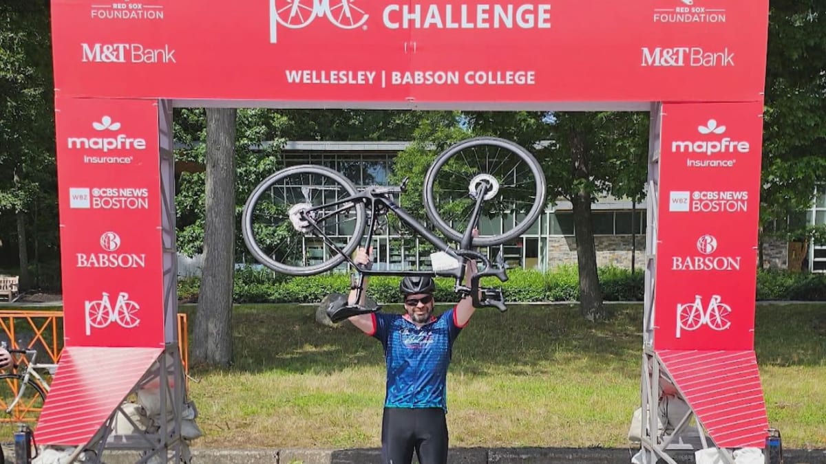 ** Cyclist crossing finish line at Pan-Mass Challenge charity bike ride for cancer research
