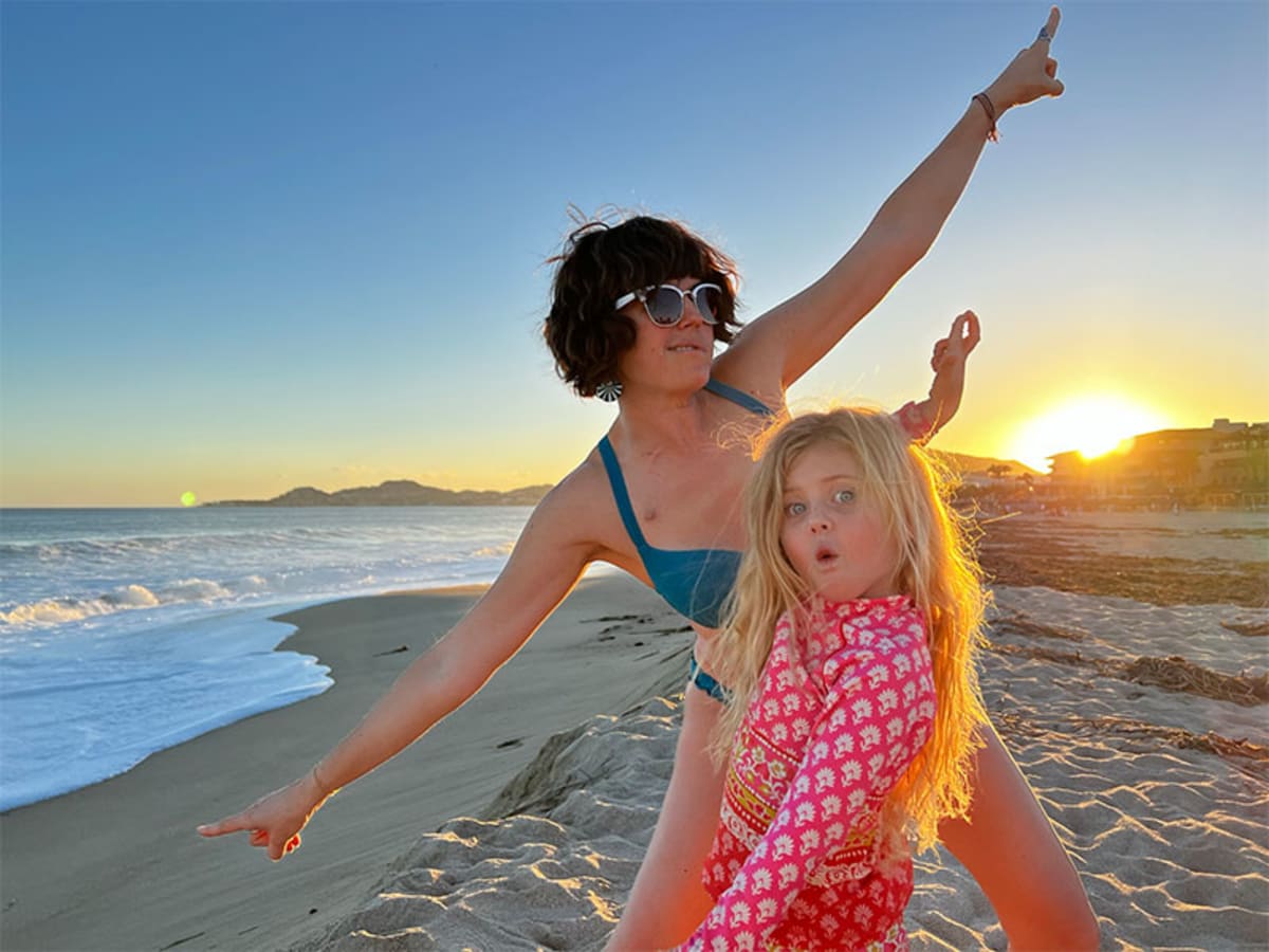 Kate Showalter smiling with her young daughter Runi after beating terminal cancer