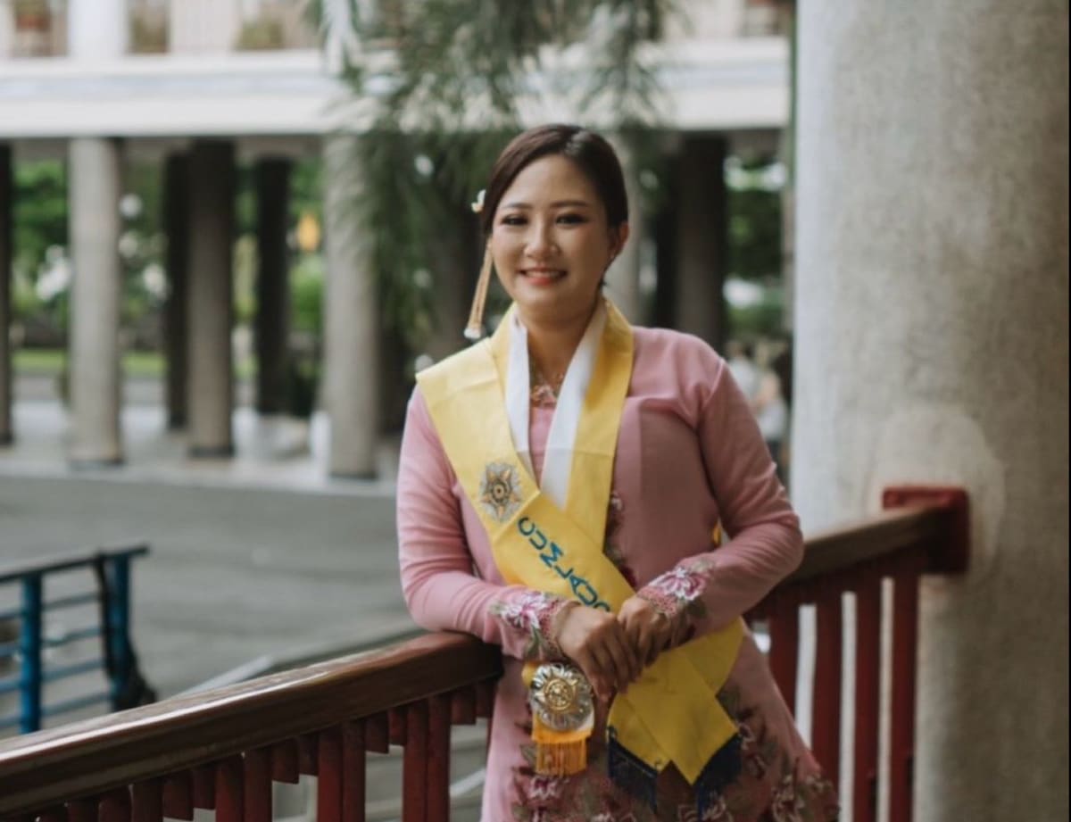 Jessy Wijaya in graduation regalia smiling after receiving her specialist dentistry degree at UGM