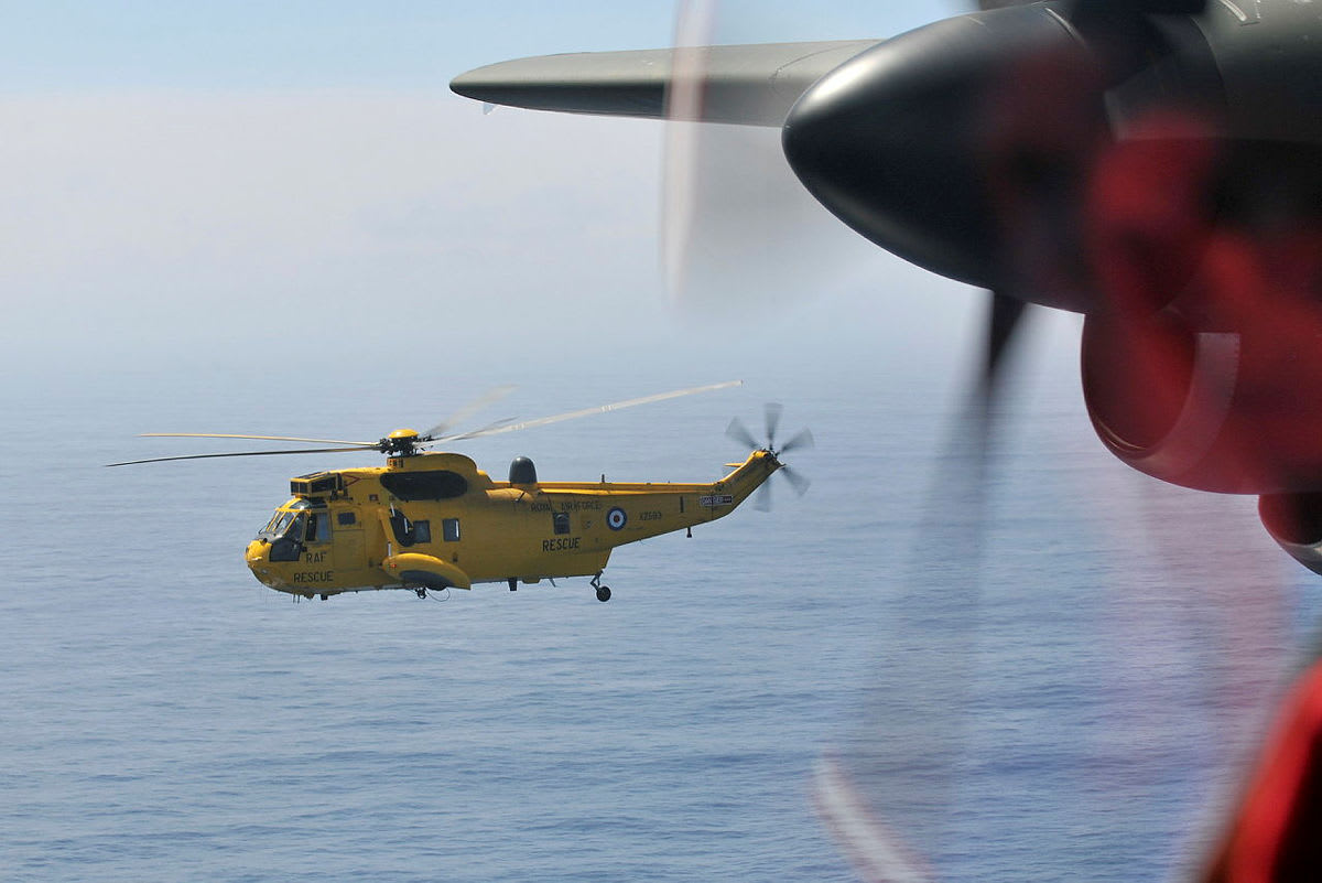 RAF search and rescue helicopter crew performing ocean rescue operation in challenging conditions