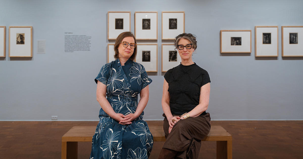 Researchers examining vintage photographs of early modern dancers at University of Kentucky museum exhibition