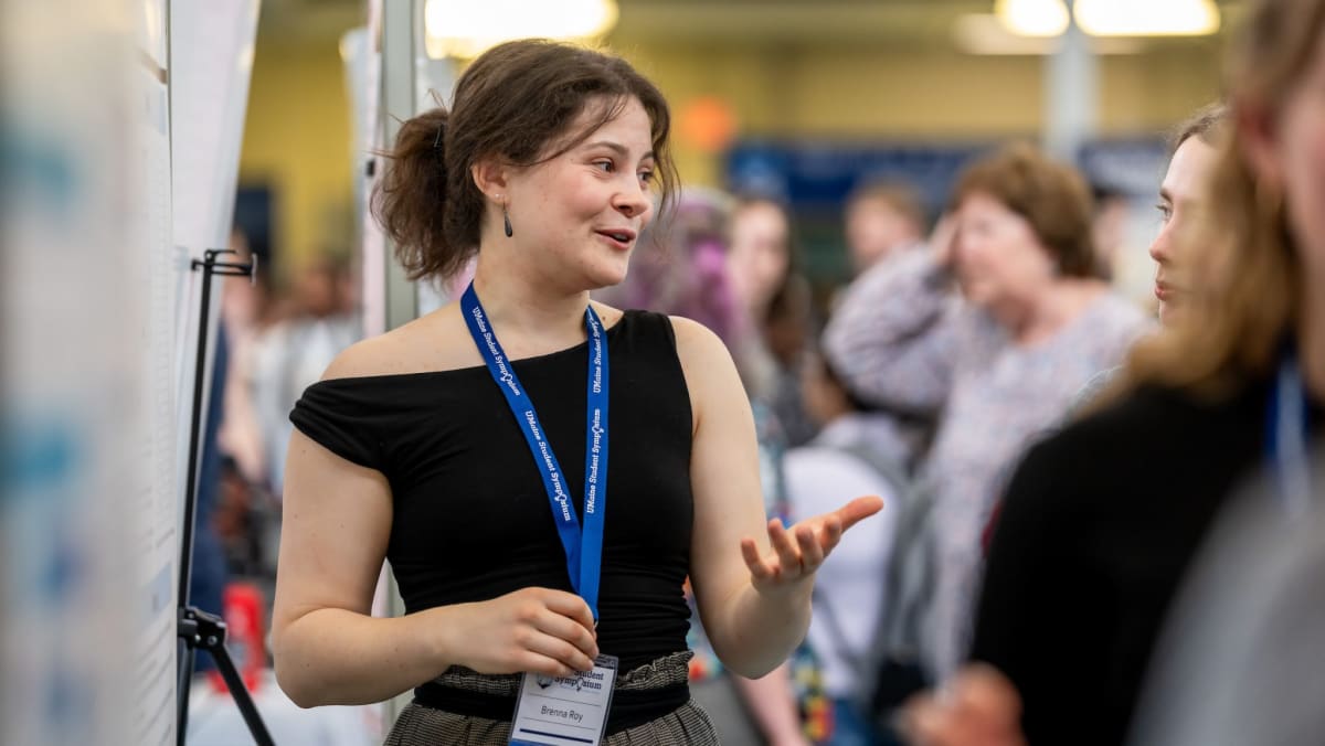 University of Maine students presenting research posters at annual symposium with community judges