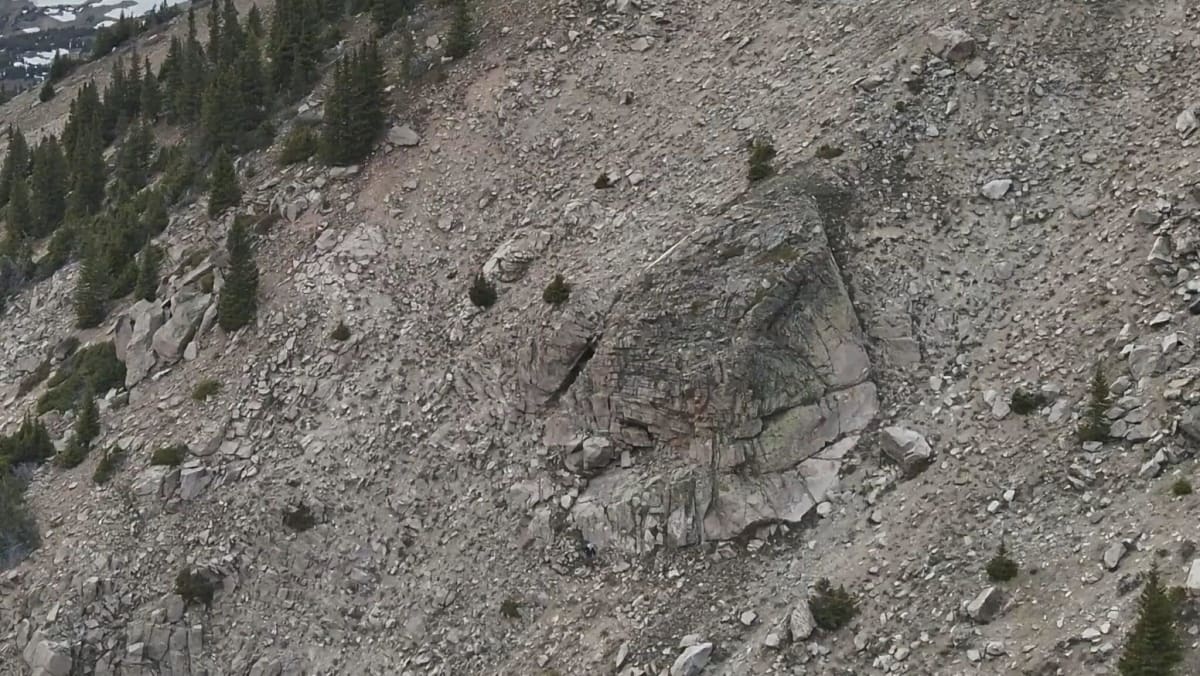 Aerial drone view of rocky wilderness terrain where camouflaged hiker was nearly invisible to rescuers
