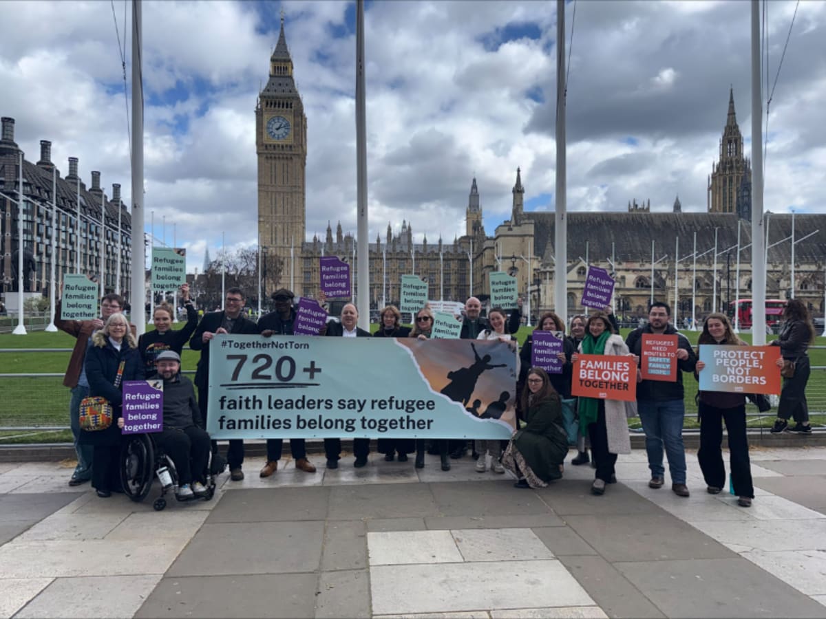 Diverse faith leaders standing together outside UK Parliament holding letter about refugee family reunion