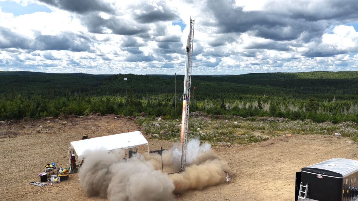 Polaris rocket launching skyward at Launch Canada Challenge with visible exhaust trail