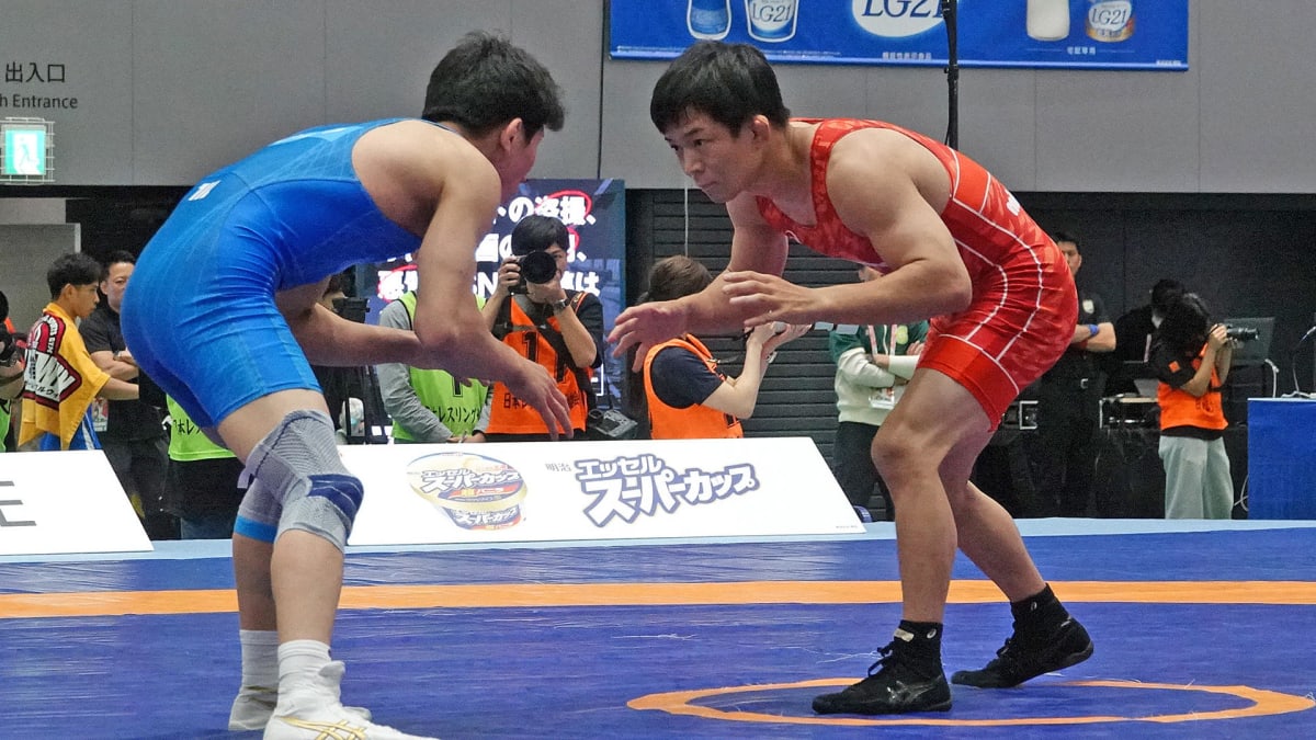 Olympic wrestling champion Kenichiro Fumita competing at Meiji Cup with head tape covering injury