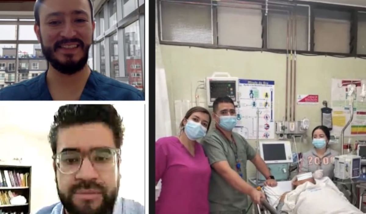 ** Doctor using telemedicine video screen to guide remote medical procedure in hospital