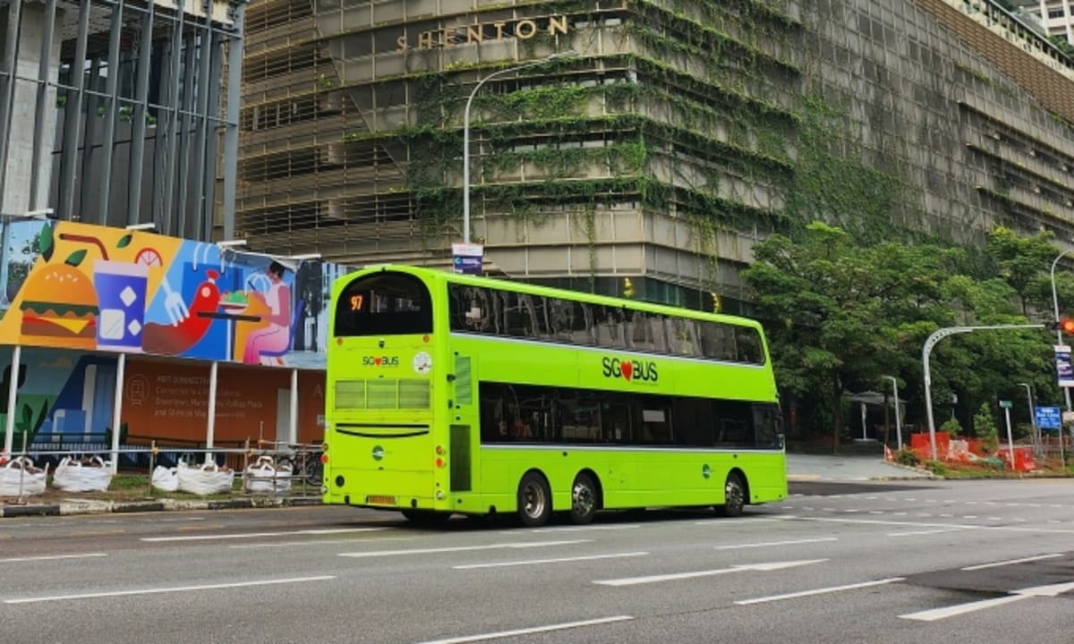 White autonomous bus with sensors and cameras mounted on exterior in Singapore