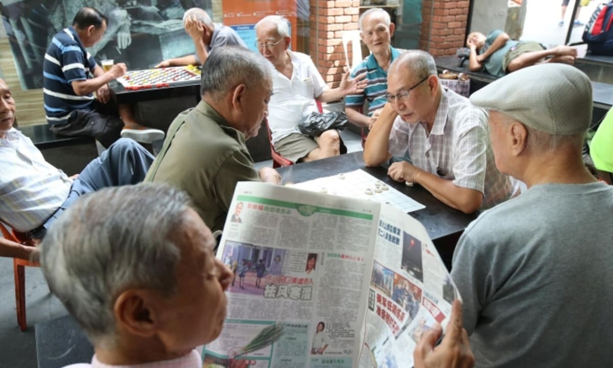 Elderly person wearing health monitoring technology in modern Singapore medical facility