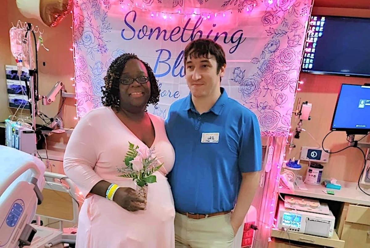 ** Bride Kandra Norris and groom Bernard Manatu smile together at their surprise hospital bedside wedding ceremony