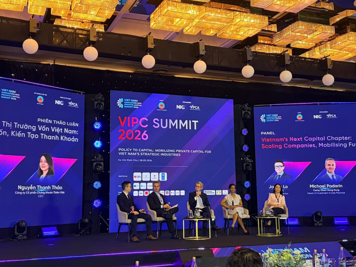 ** Business professionals discussing investment strategy at Vietnam private capital summit panel