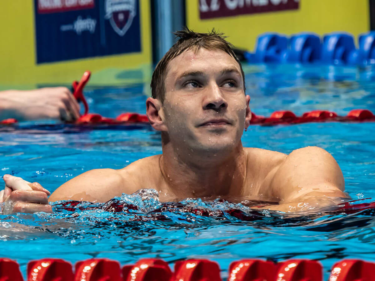Olympic swimmer Ryan Murphy celebrating on podium wearing USA team gear and medal