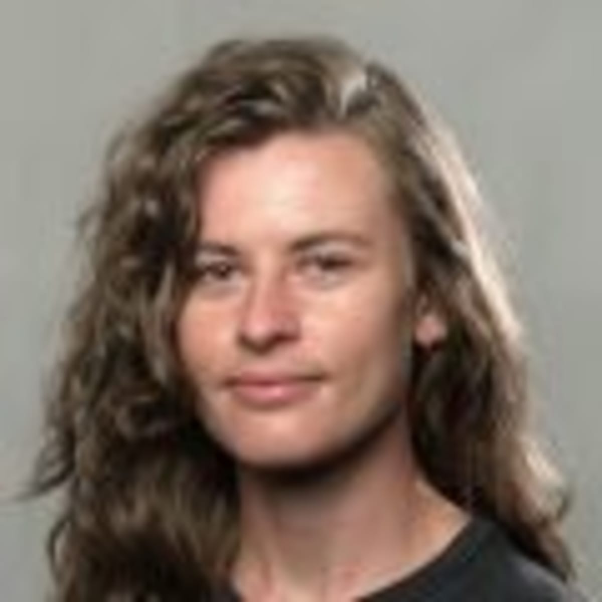 Volunteer Chris Johnson holds a small spring peeper frog while helping it cross a road safely