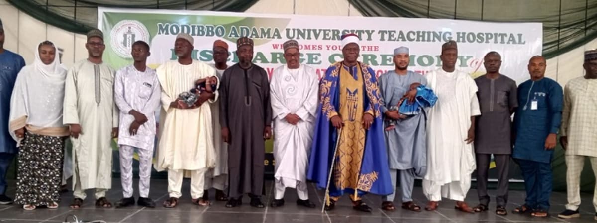 Medical team celebrating successful separation surgery of conjoined twins at Nigerian teaching hospital