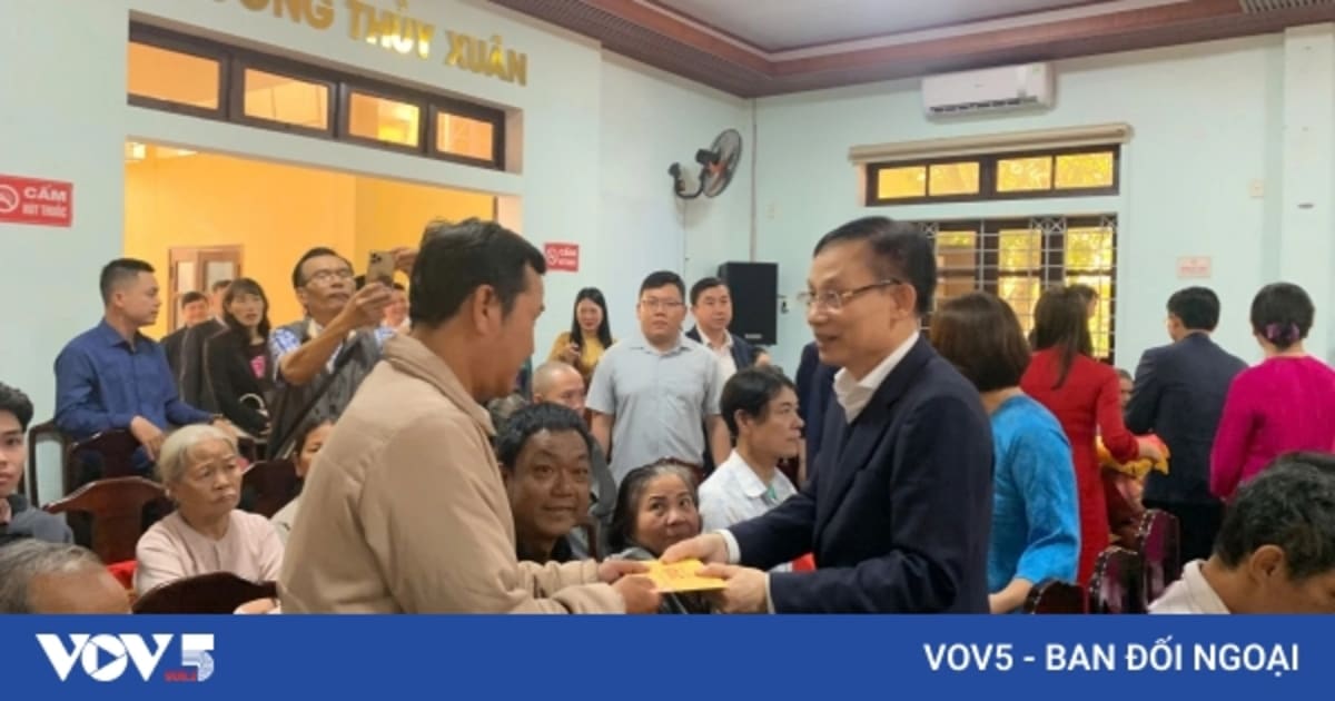 Vietnamese officials presenting Lunar New Year gift packages to families in need during Tet celebration
