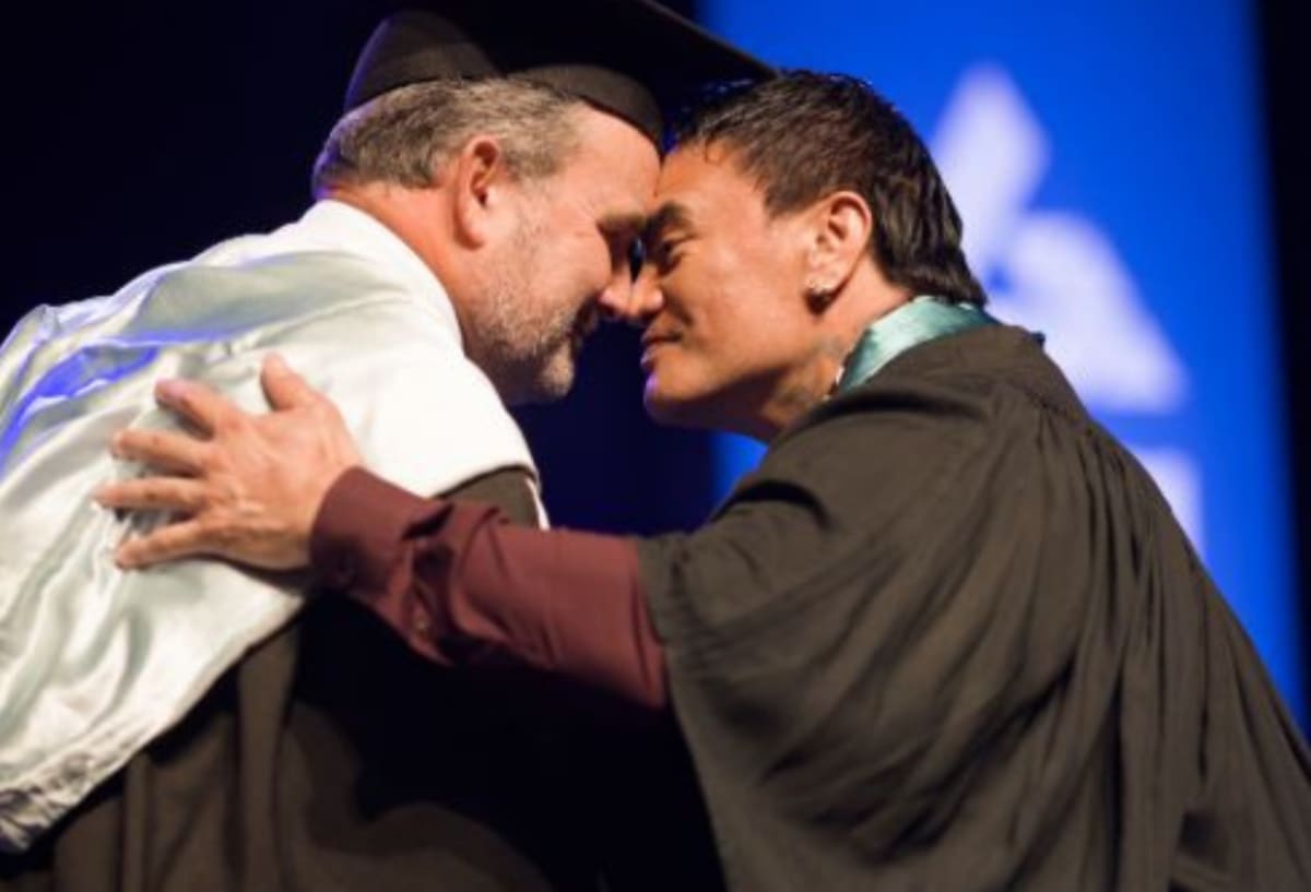 Graduates in academic regalia celebrating at Ara Institute of Canterbury graduation ceremony