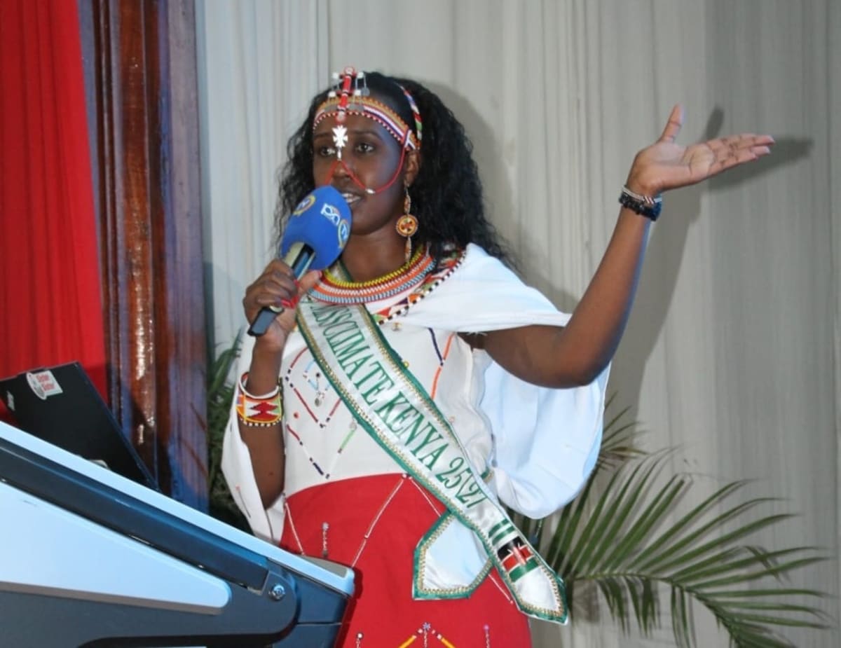 Hillary Semeyan Lenantoiye speaking at podium at Mr. and Mrs. Climate Kenya event