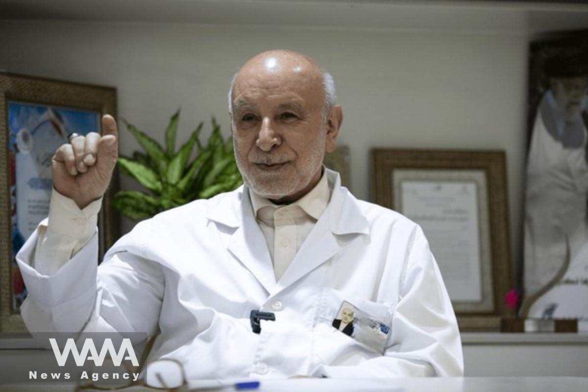 Medical researcher examining cancer treatment data in laboratory setting with advanced equipment