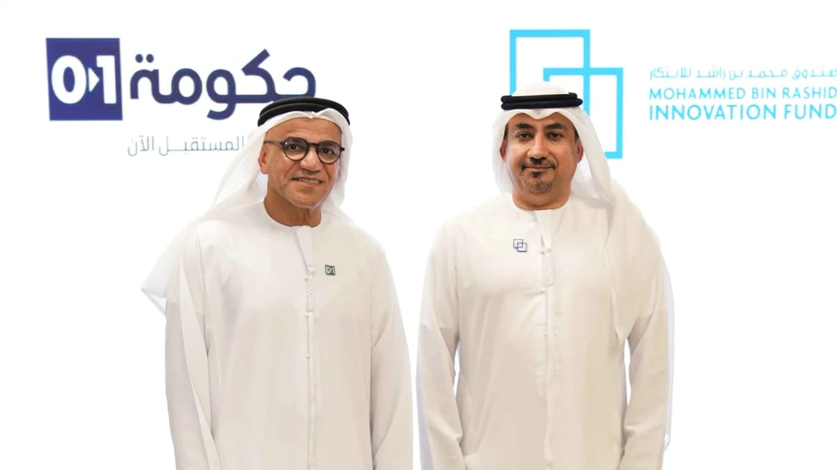 Dubai government workers using AI technology platform on computer screens in modern office