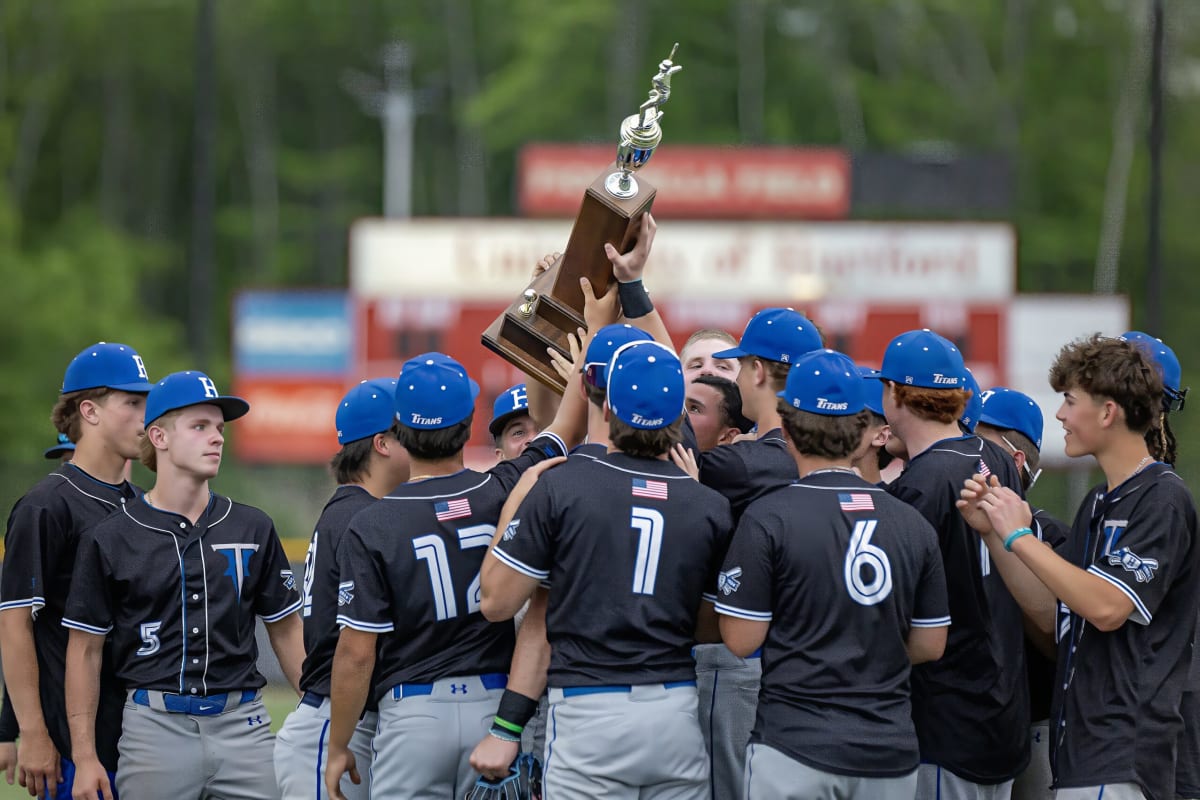 Hall High School baseball team celebrating with Mayor's Cup trophy after comeback victory