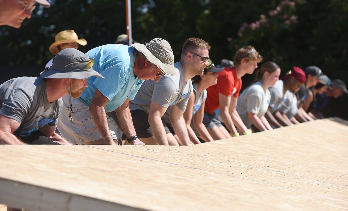 Volunteers and future homeowners working together on Habitat for Humanity home construction site in Chattanooga