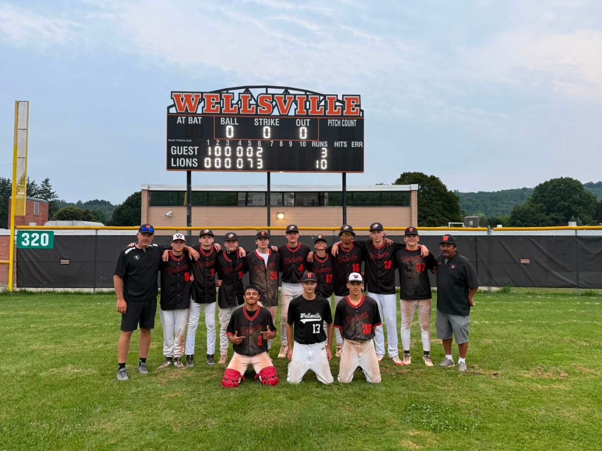 Wellsville Senior League baseball team posing together with coaches after championship victory