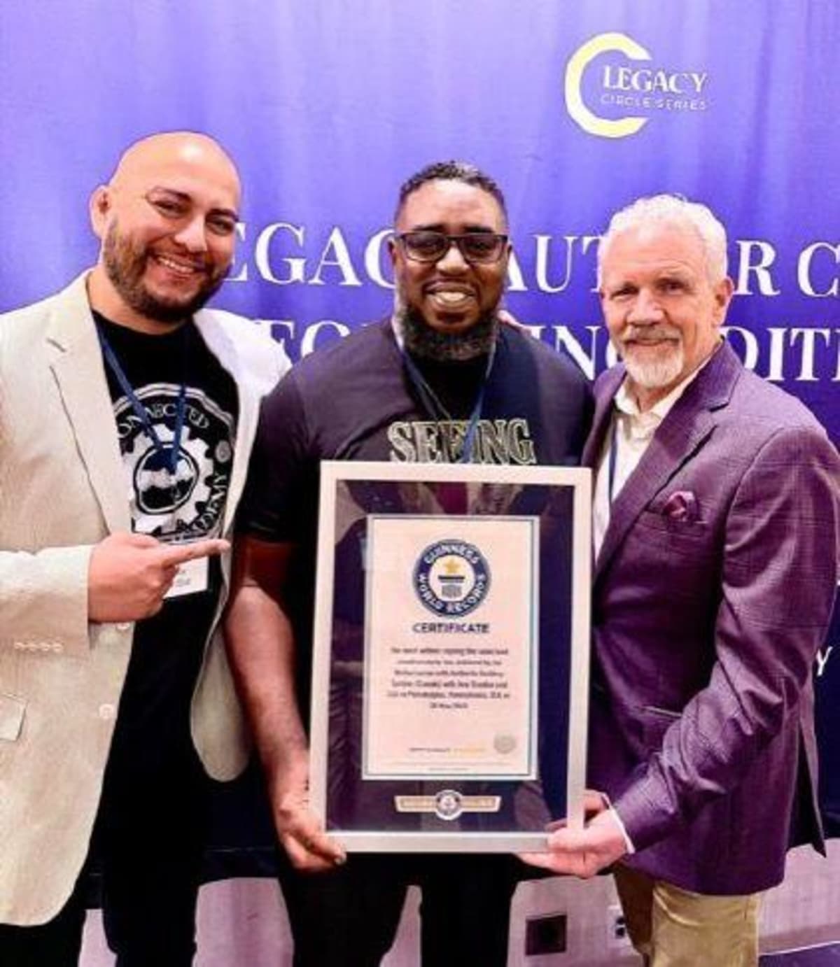 Stephen T. Miller celebrates with fellow authors holding Guinness World Records certificate in Philadelphia