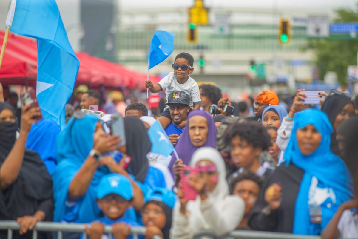 Crowd of people enjoying outdoor music performance at Minnesota Somali Day Festival celebration