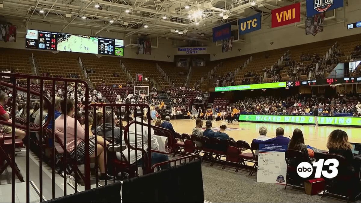 Volunteer Stephen Zubrod serves drinks at the SoCon Basketball Championships in Asheville, North Carolina