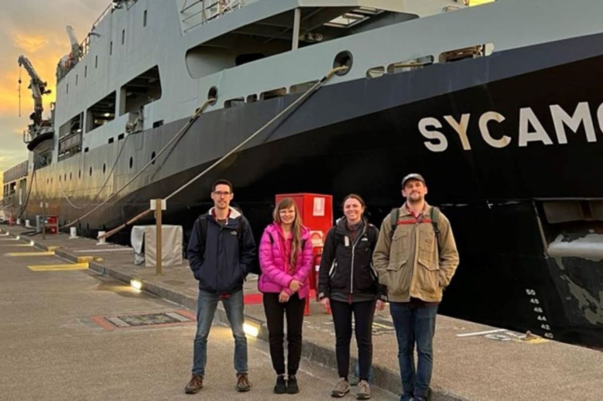 Researchers working on portable atomic clock equipment aboard Australian naval vessel