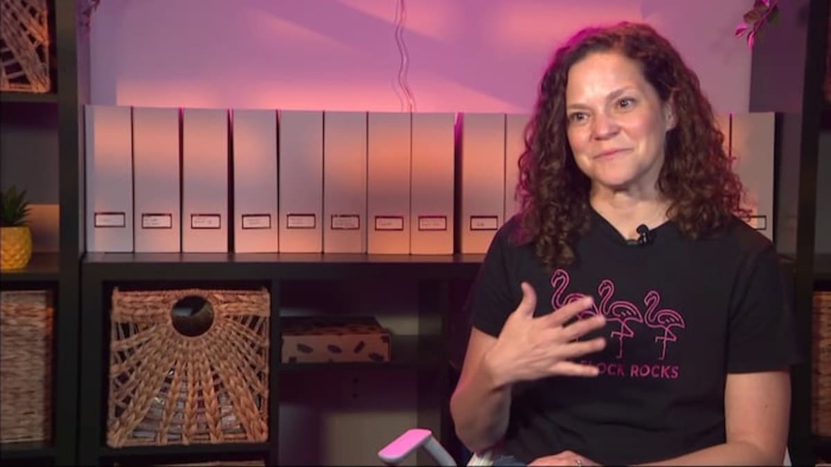 Rosemary Carrera smiling in her office surrounded by photos of cancer patients and families