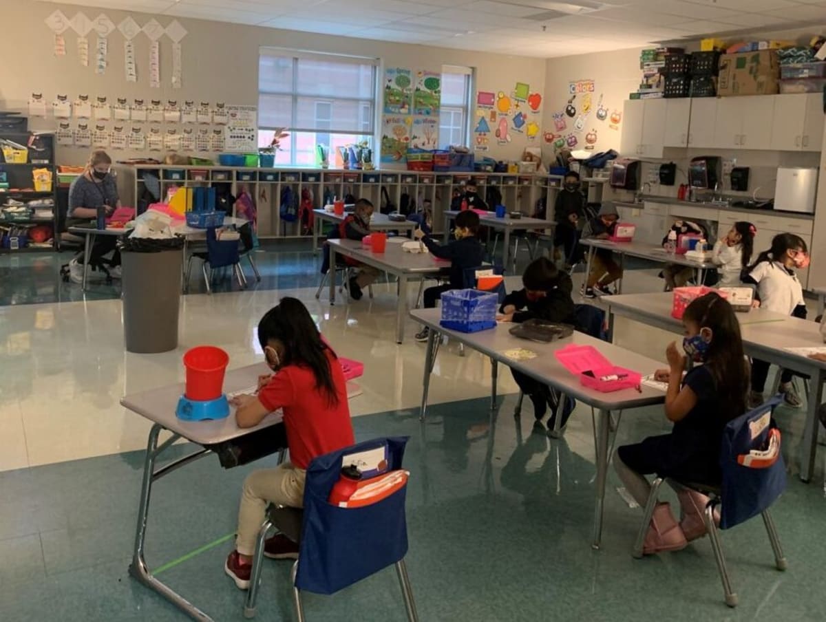 Tennessee elementary school students working together on math problems in bright classroom