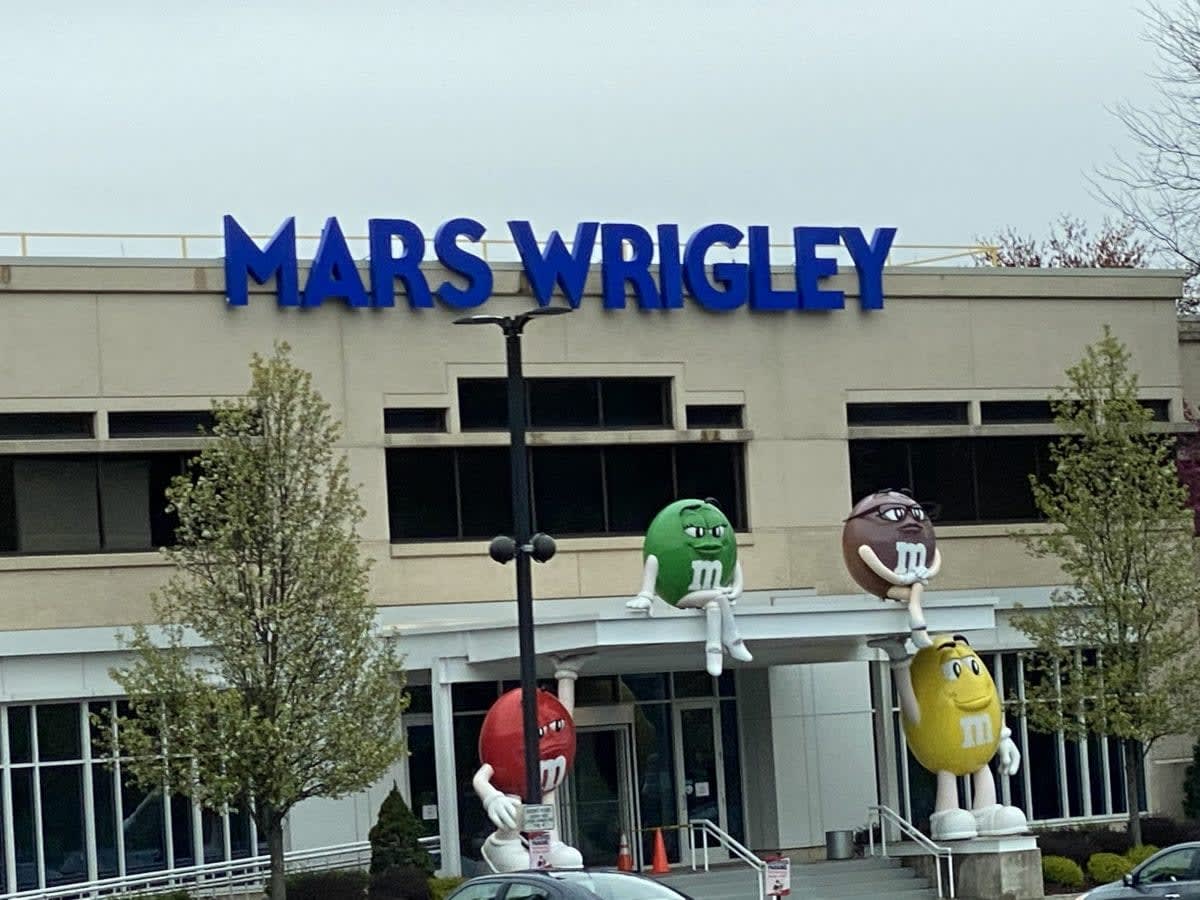 Solar panels powering Mars factory with M&Ms brand visible on building exterior