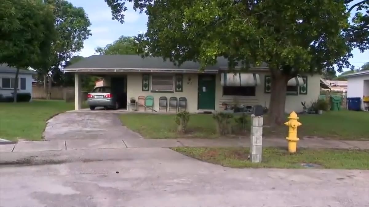 Firefighters responding to house fire with smoke visible from residential building in Lauderhill
