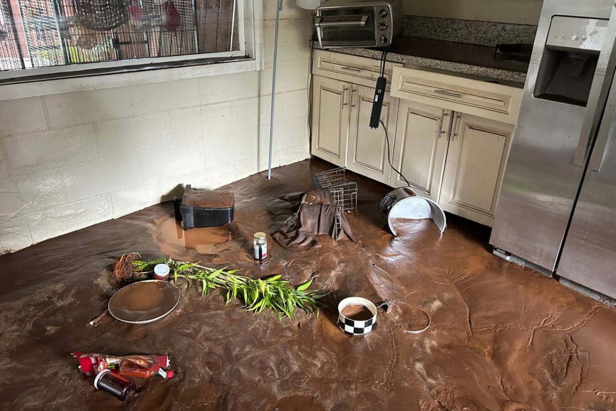 Red volcanic mud covering kitchen floor after historic Hawaii flooding March 2026