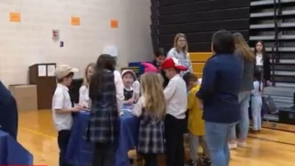 Students at St. Joan of Arc School packing backpacks with essential supplies for homeless community members