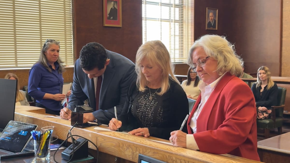 Three CASA volunteers being sworn in by judge in Dauphin County courthouse ceremony