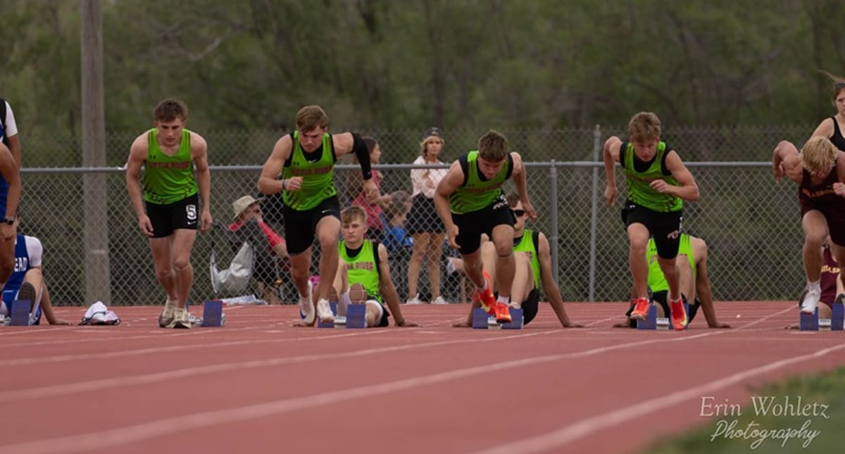 High school track athlete competing in sprint race on outdoor track