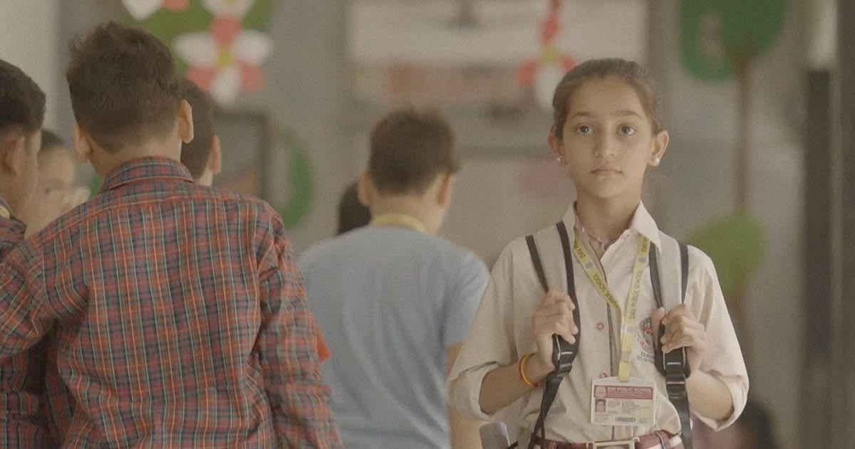 Students sitting in Indian classroom with camera monitoring for safety and wellbeing