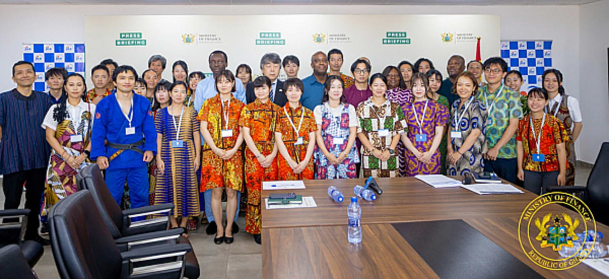 Japanese JICA volunteers meeting with Ghana's Deputy Finance Minister in official government setting