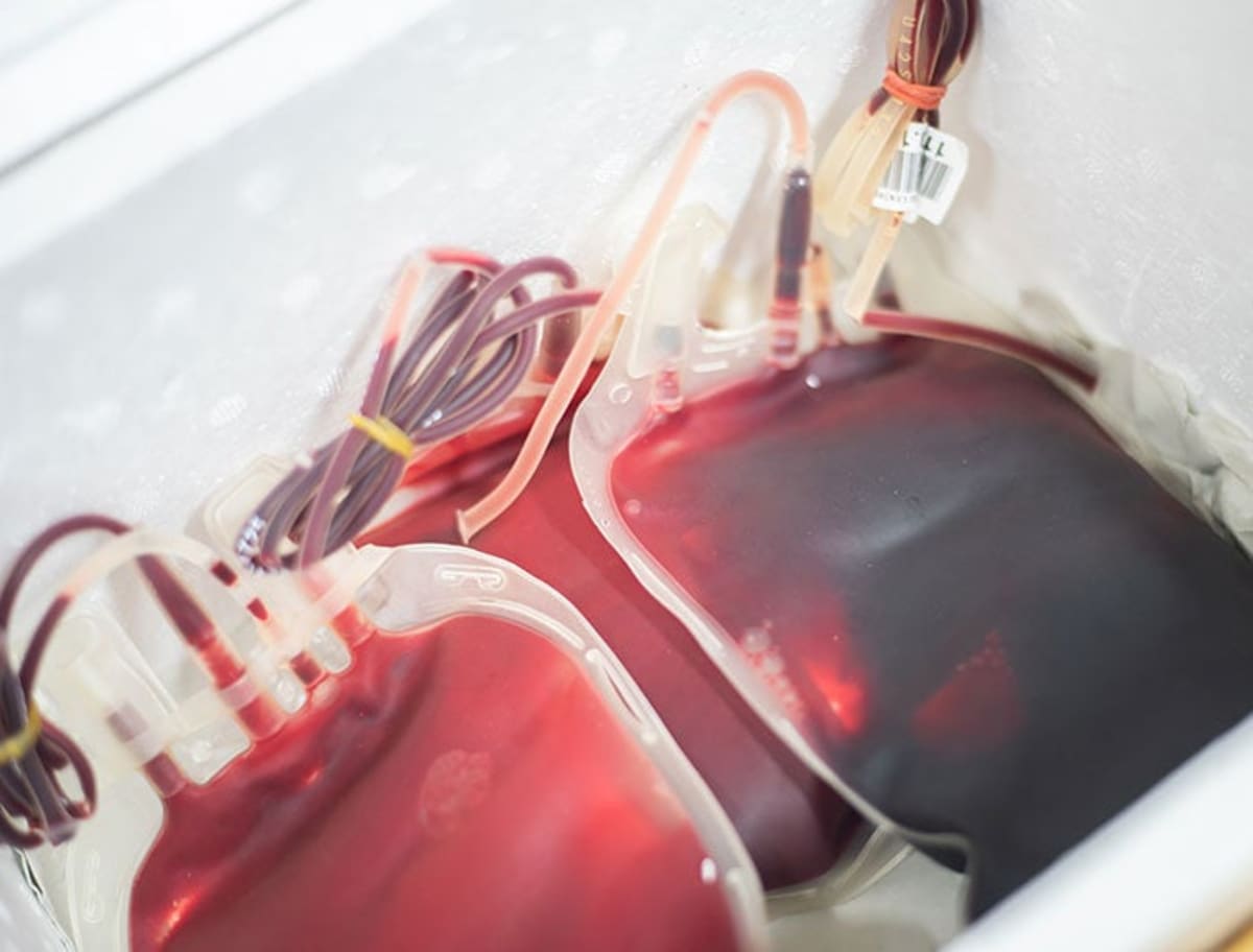 AtlantiCare paramedic preparing whole blood transfusion equipment inside mobile intensive care ambulance