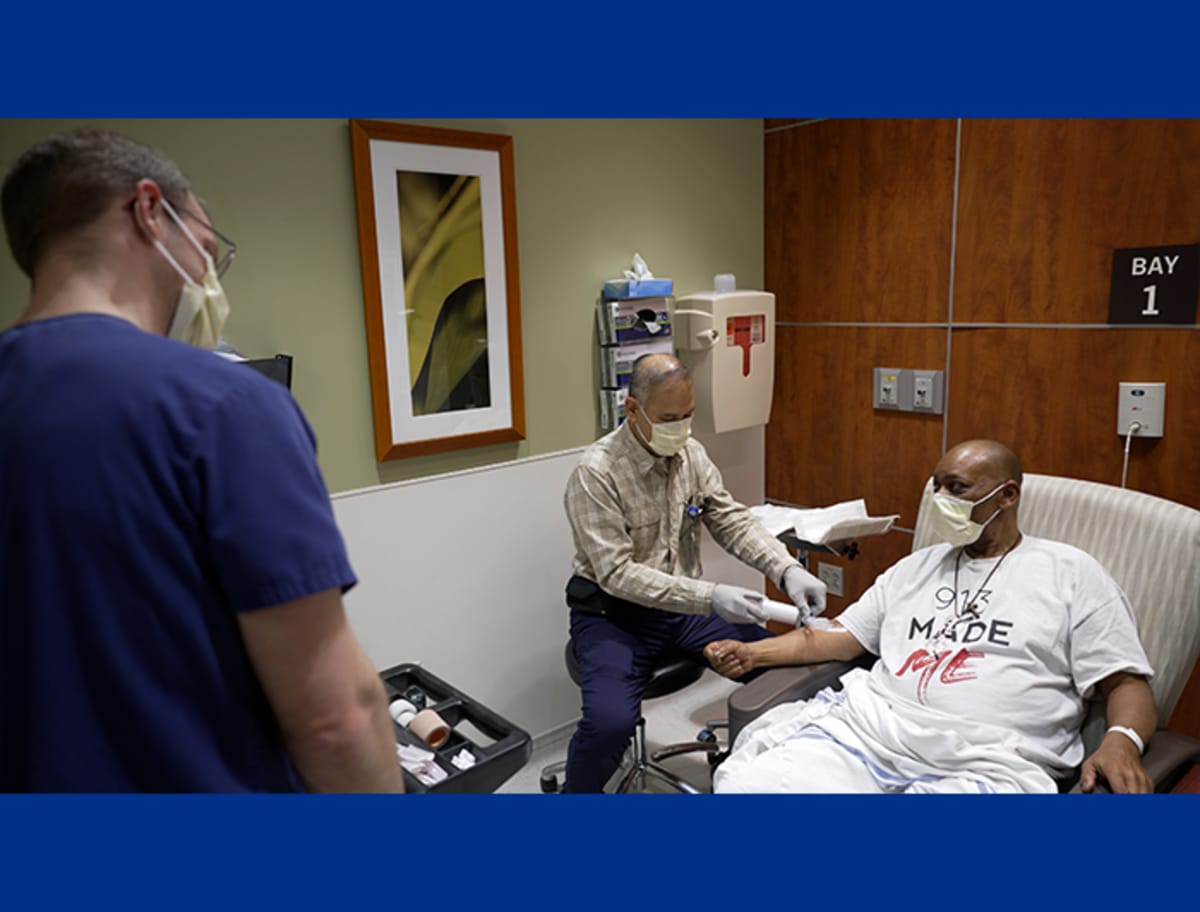 Medical professionals in Kansas City healthcare facility collaborating on advanced cancer treatment technology