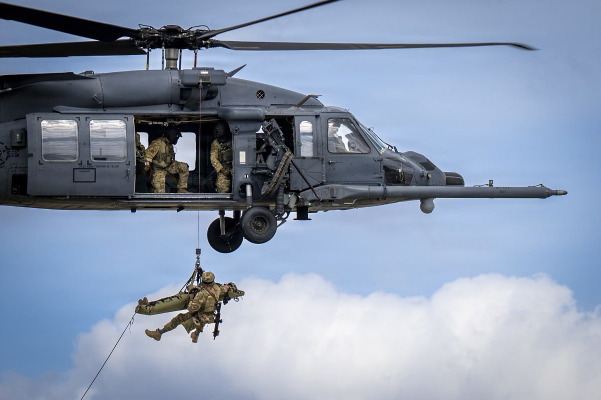 Military rescue helicopters flying in formation during complex combat search and rescue operation