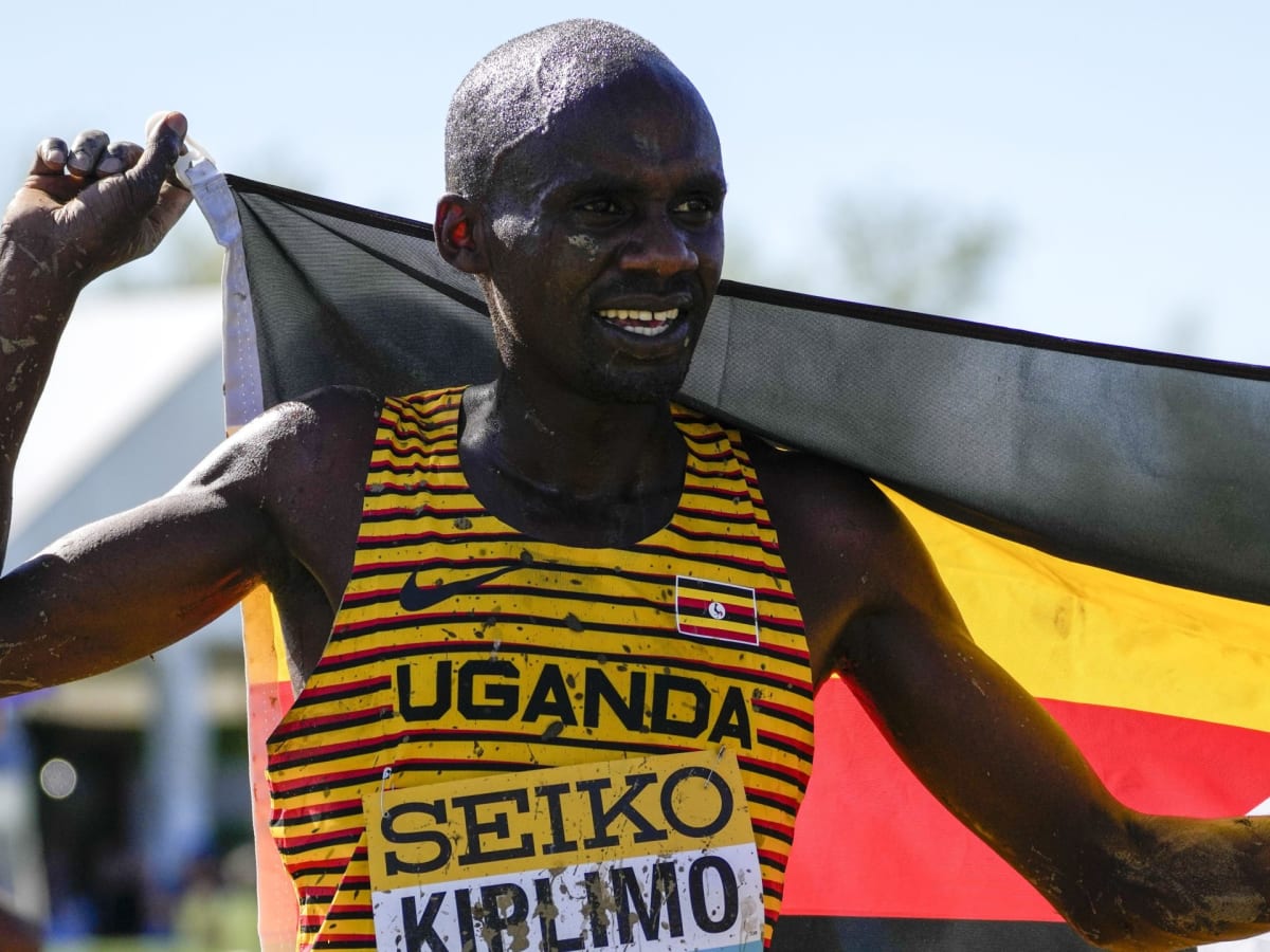 Ugandan runner Jacob Kiplimo crossing finish line in celebration after breaking half-marathon world record