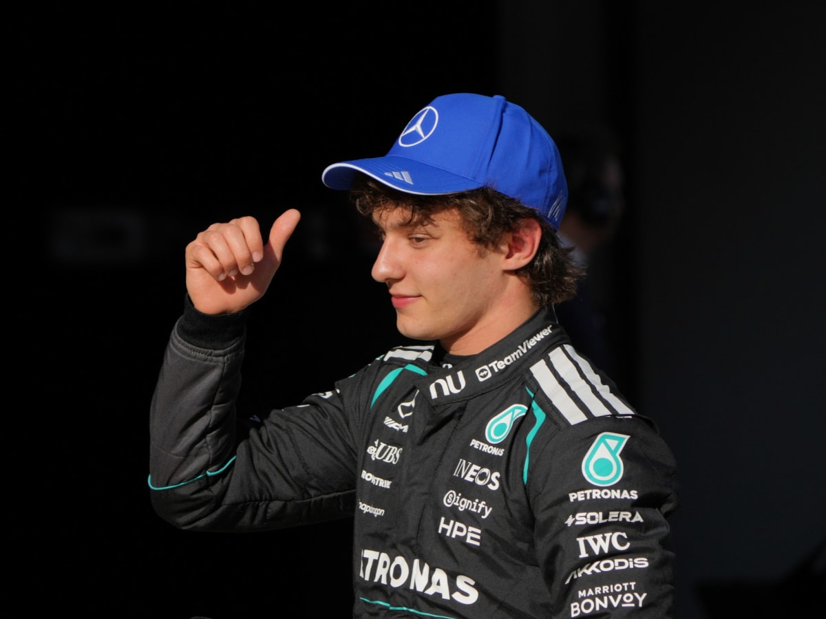 Young Formula One driver Kimi Antonelli celebrating pole position achievement in Mercedes racing gear